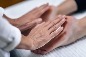 Hands,Of,Reiki,Therapist,Healing,And,Balancing,Feet,Chakras.,Energy